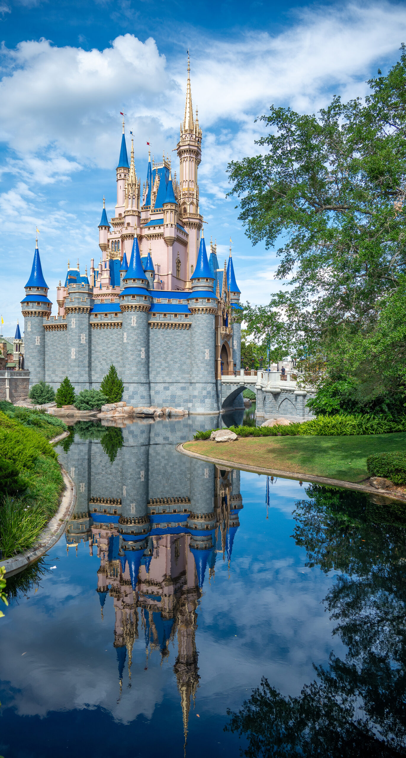 Side view of Cinderella castle in Disney World with a water refl